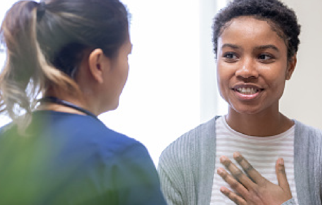 Photo of 2 people having a conversation.