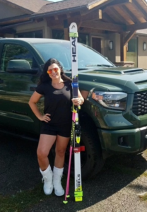 Danelle stands with her skis.